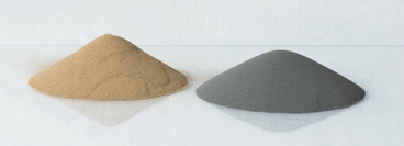 Two cone-shaped piles of different metal powders
