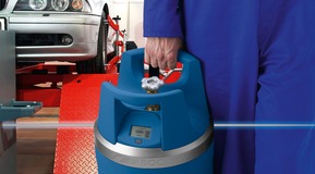 A GENIE gas cylinder being used for automative maintenance